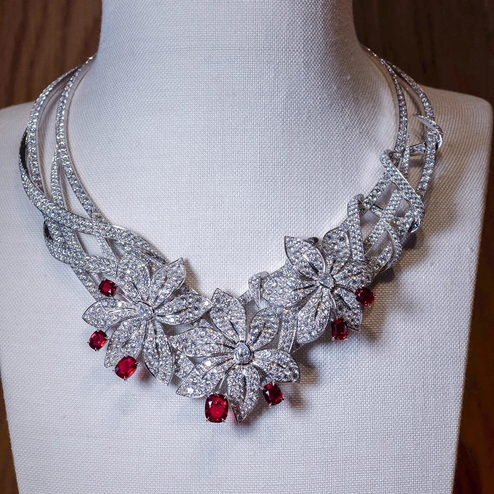<p>Three blooms are positioned side by side on the Sword-Lily necklace, their curved diamond petals overlaying a lattice of vines</p>
