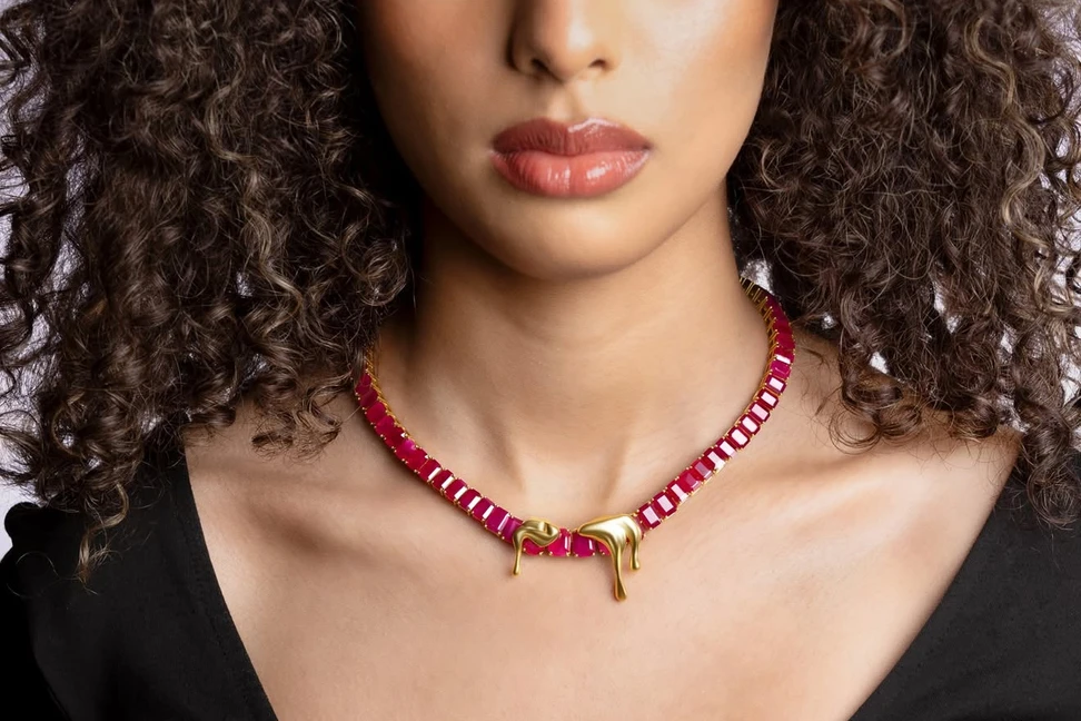 <p>Moody Jewellery 1064 pendants in 18k yellow gold, held by a ruby necklace. The collection is named after the melting point of gold</p>
