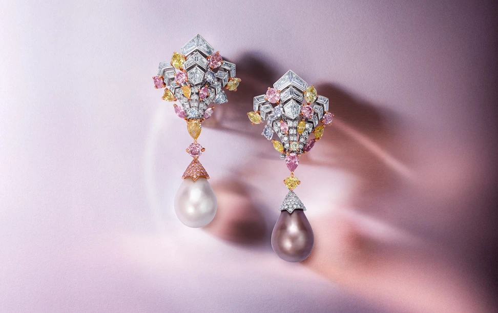 <p>Kismet High Jewellery earrings with a 25.72ct natural greyish-brown pearl, 22.90ct natural white pearl, 4.34ct pink diamonds, 3.17ct yellow diamonds, 0.75ct orange diamonds, 0.65ct blue diamonds, 0.16ct red diamonds, 0.23ct grey diamonds and 7.42ct white diamonds set in 18ct rose and white gold</p>