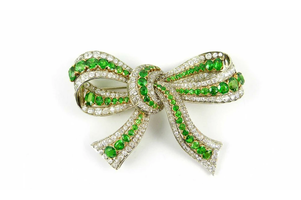 <p>Demantoid garnet and diamonds bow brooch c. 1920 available at S.J. Phillips</p>
