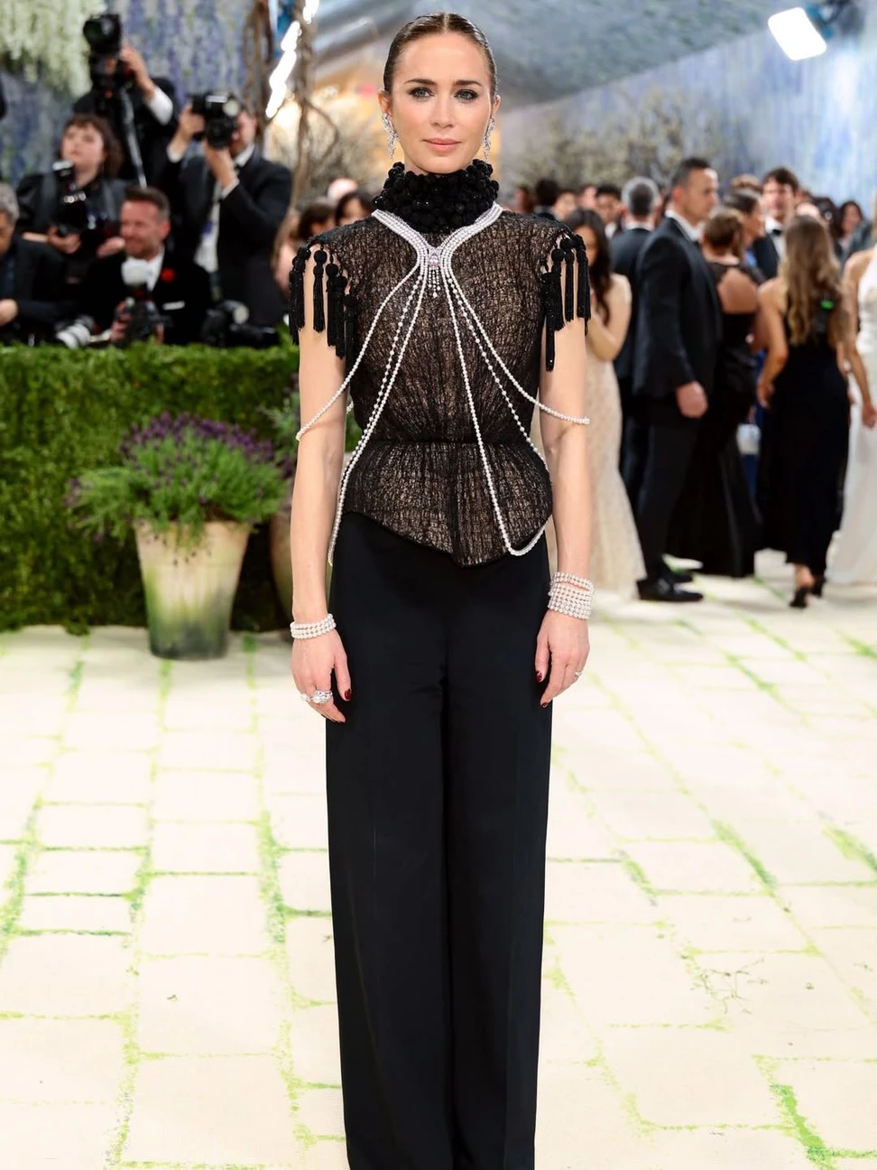 <p>Emily Blunt overlaid her tassel-shouldered top with an extraordinary Mikimoto body jewel composed of cascading strands of Akoya pearls</p>