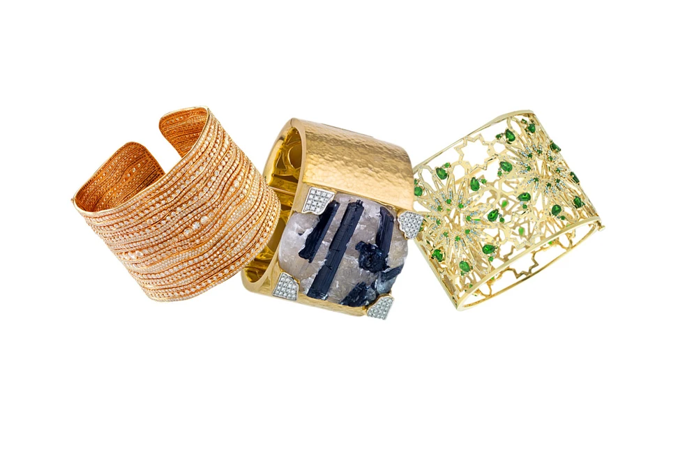 <p>From left to right: Etho Maria rose gold and diamonds cuff; Jorge Adeler gold cuff with a raw tourmaline and diamonds; Octium 18k yellow gold Interlocking cuff with light blue topaz, chrome diopside and diamonds</p>