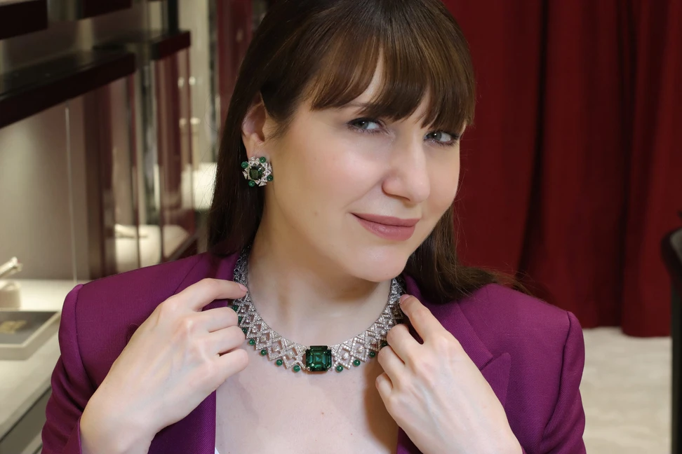 <p>Katerina Perez wears the Jaipur Gems Soraya necklace with a 48-carat bluish-green tourmaline from Afghanistan, surrounded by diamonds and emeralds in a geometric design, alongside the Emerald Dewdrop earrings with 15 carats of tourmalines, emeralds and diamonds</p>
