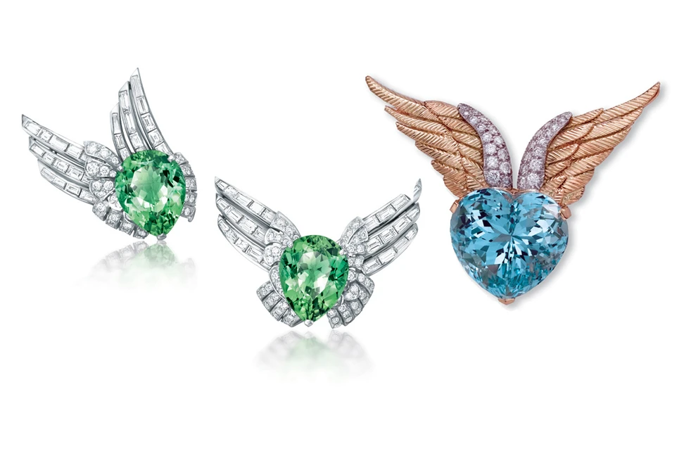 <p>Left: Verdura Winged brooches with mint tourmaline and diamonds. Right: Verdura Winged Heart brooch with an aquamarine and diamonds</p>