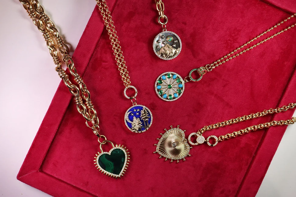 <p>A selection of Medallions by Lionheart, including the colourful Serenity Amulet charm with 1.15 carats of diamonds, 0.95 carats of oval-shaped emeralds and 1.06 carats of turquoise cabochons, set in 14k yellow gold</p>
