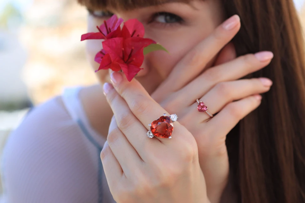 <p>Katerina Perez wears heart-shaped cocktail rings by Lisa Nik, including a rubellite tourmaline with diamond side stones and a pink tourmaline ring in 18k rose gold </p>

