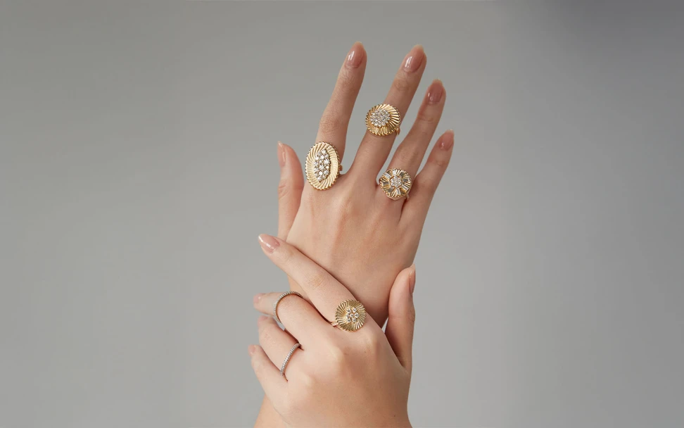 <p>A model wears rings from the Seven Sisters collection by Marceline Paris, including the Nebula Cloud ring (left, centre) with 1.35 carats of diamonds in 18k yellow gold</p>
