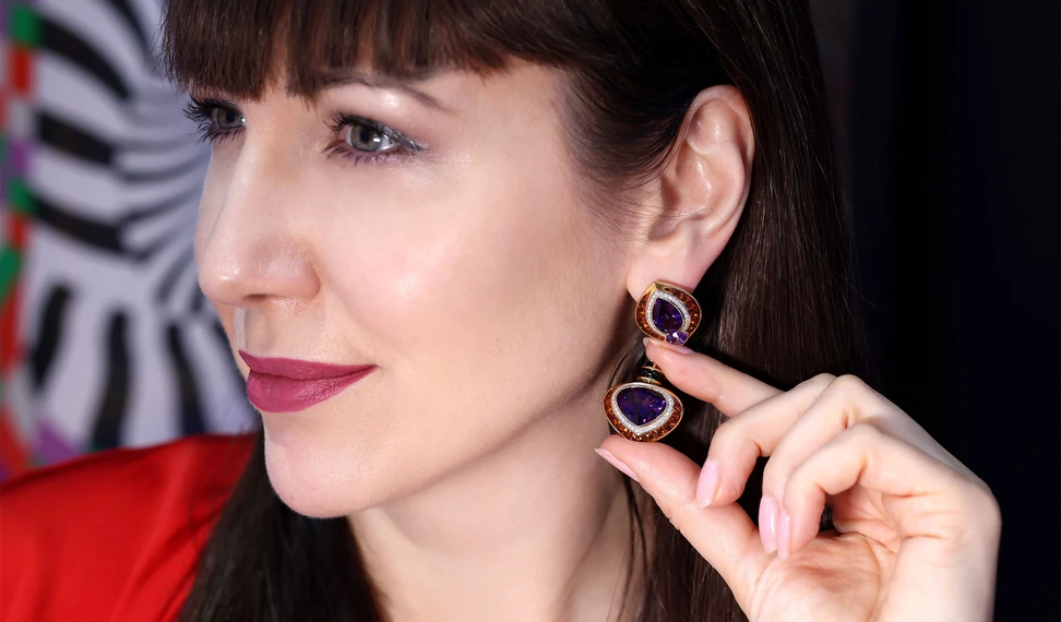 <p>Katerina wears the Ortensia high jewellery earrings, set with 13.20ct amethysts, 4.67ct Mexican fire opals, 4.78ct buff-top citrines, pavé diamonds and black onyx in 18k yellow gold</p>