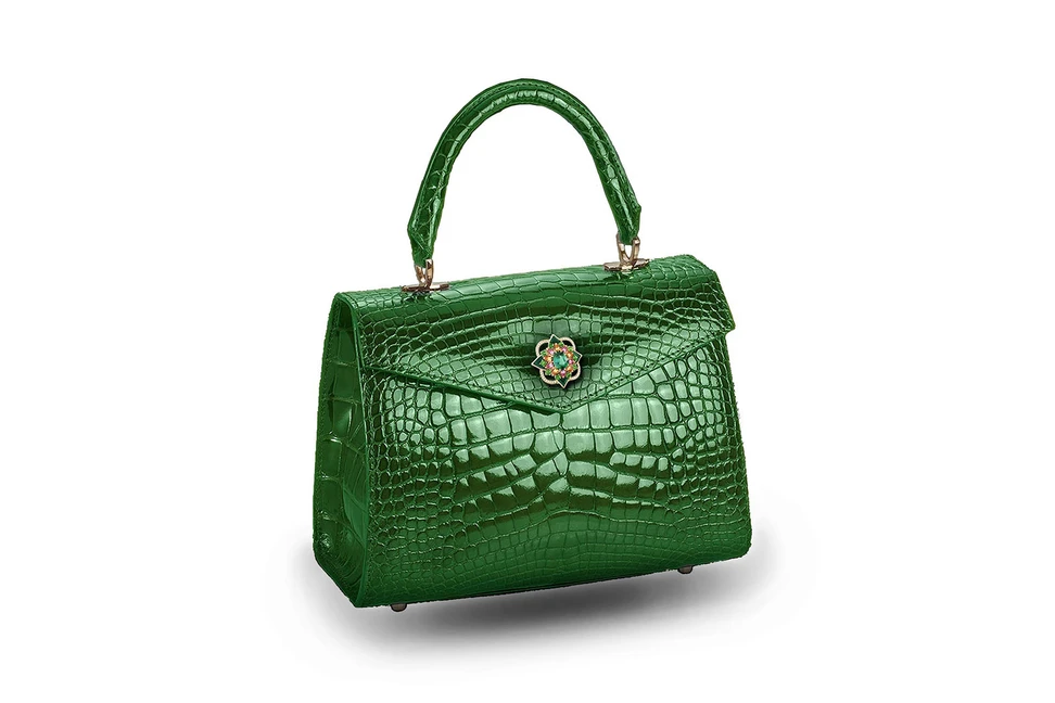 <p>Mellerio dits Meller and Ethan Koh &#8216;Alla&#8217; bag with the ‘Giardino’ brooch from ‘Isola Madre’ collection in tourmaline, tsavorite, pink sapphire, spessartite garnets, diamonds and green enamel</p>
