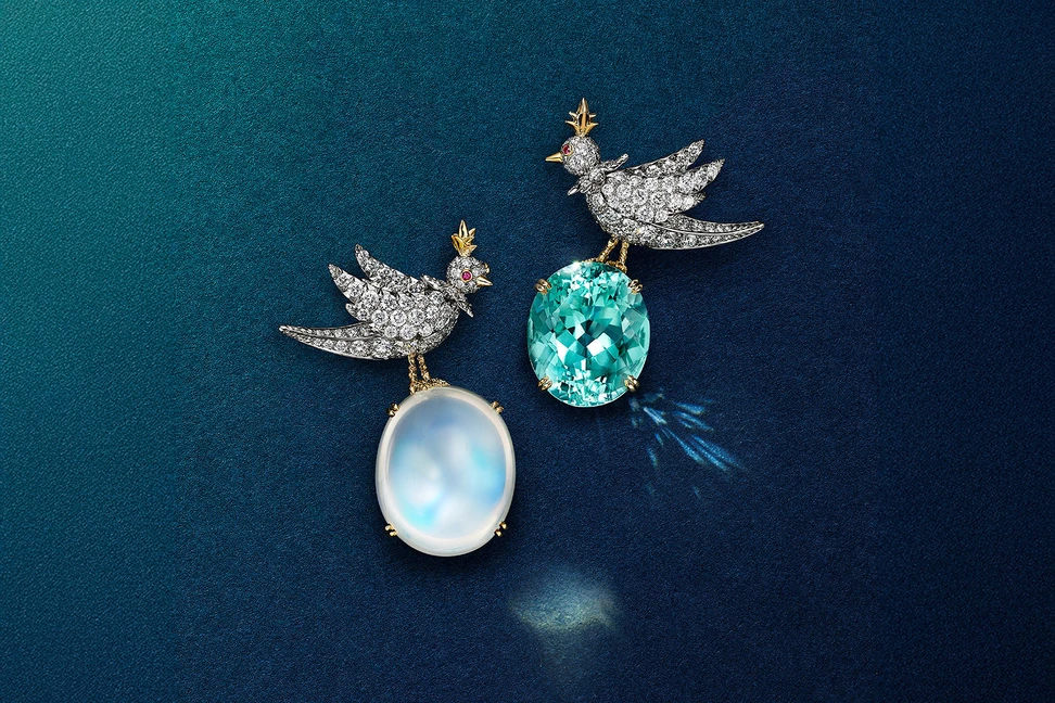 <p>Tiffany & Co. Bird on a Rock: Love Birds high jewellery brooches in platinum and 18k yellow gold, set with an an oval cabochon moonstone of 45.04 carats and an oval blue cuprian elbaite tourmaline of 21.13 carats</p>