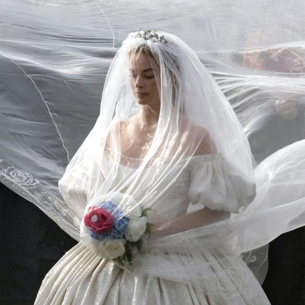 <p>Made in white metal and formed from winding leaves, Margot Robbie”s bridal tiara is VIctorian-esque</p>