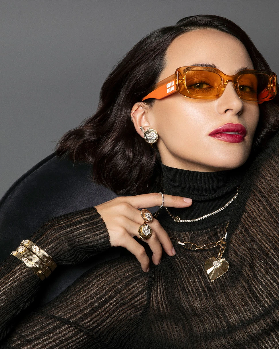 <p>A model wears bracelets, earrings and rings from the Seven Sisters collection by Marceline Paris, alongside the Heart of the World necklace from the Love Frequency collection</p>
