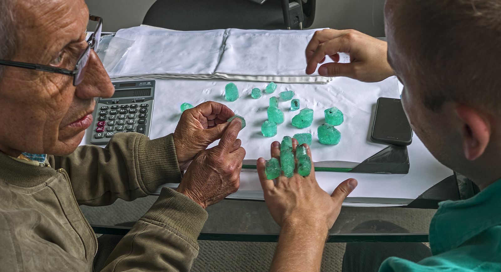 George Smith of the International Emerald Exchange sorts through emerald rough