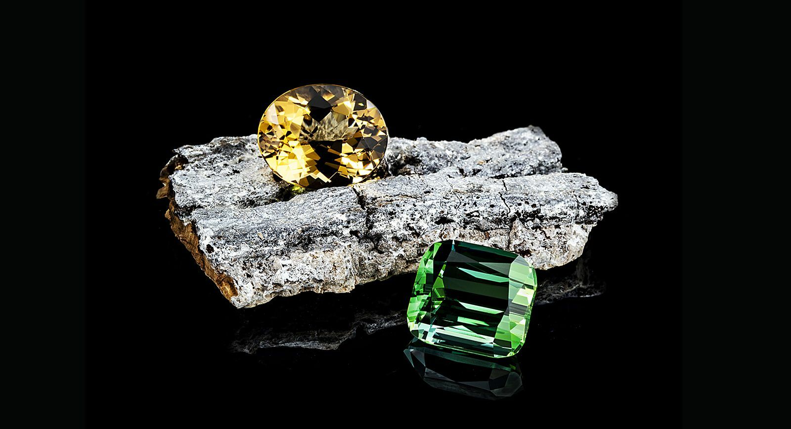 Gemstone Cutting Company Gebrüder Meelis presenting an 11.83 carat yellow beryl and a 17.08 carat tourmaline