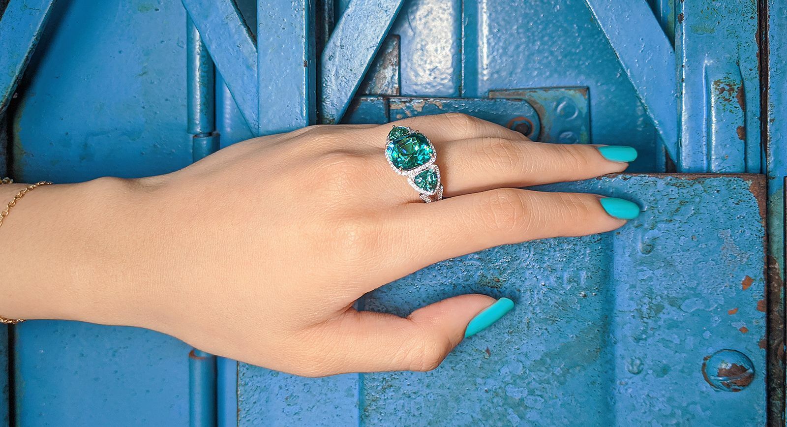 Madly indicolite tourmaline trilogy ring with trillion cut lagoon tourmalines and diamonds