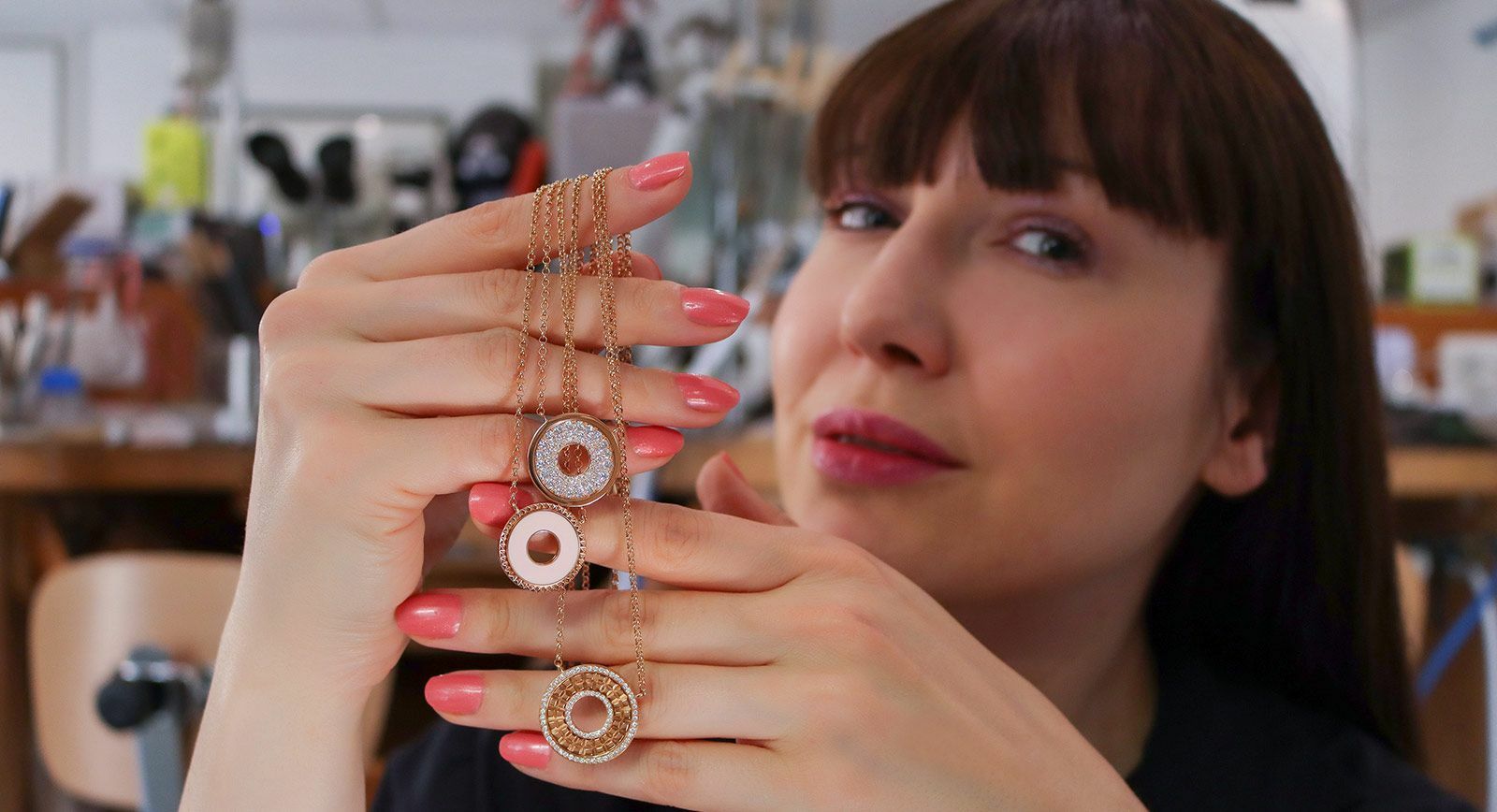 Katerina Perez holds three pendants by Ferrat Paris