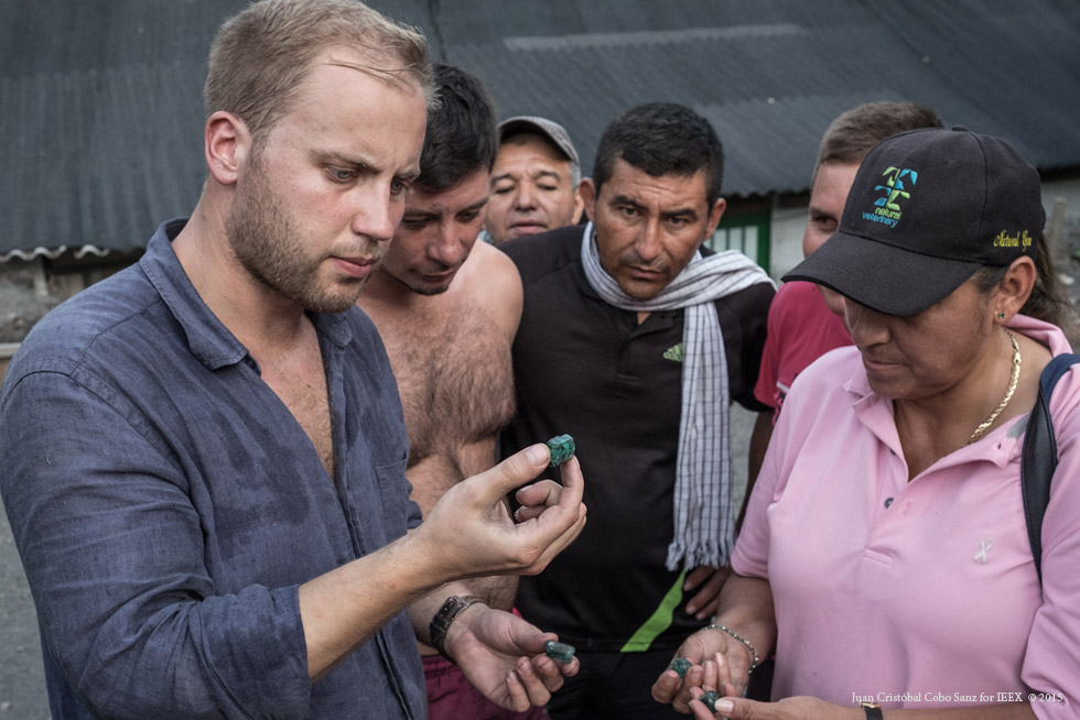   Gorge and some local people scrutinise freshly – mined emeralds.