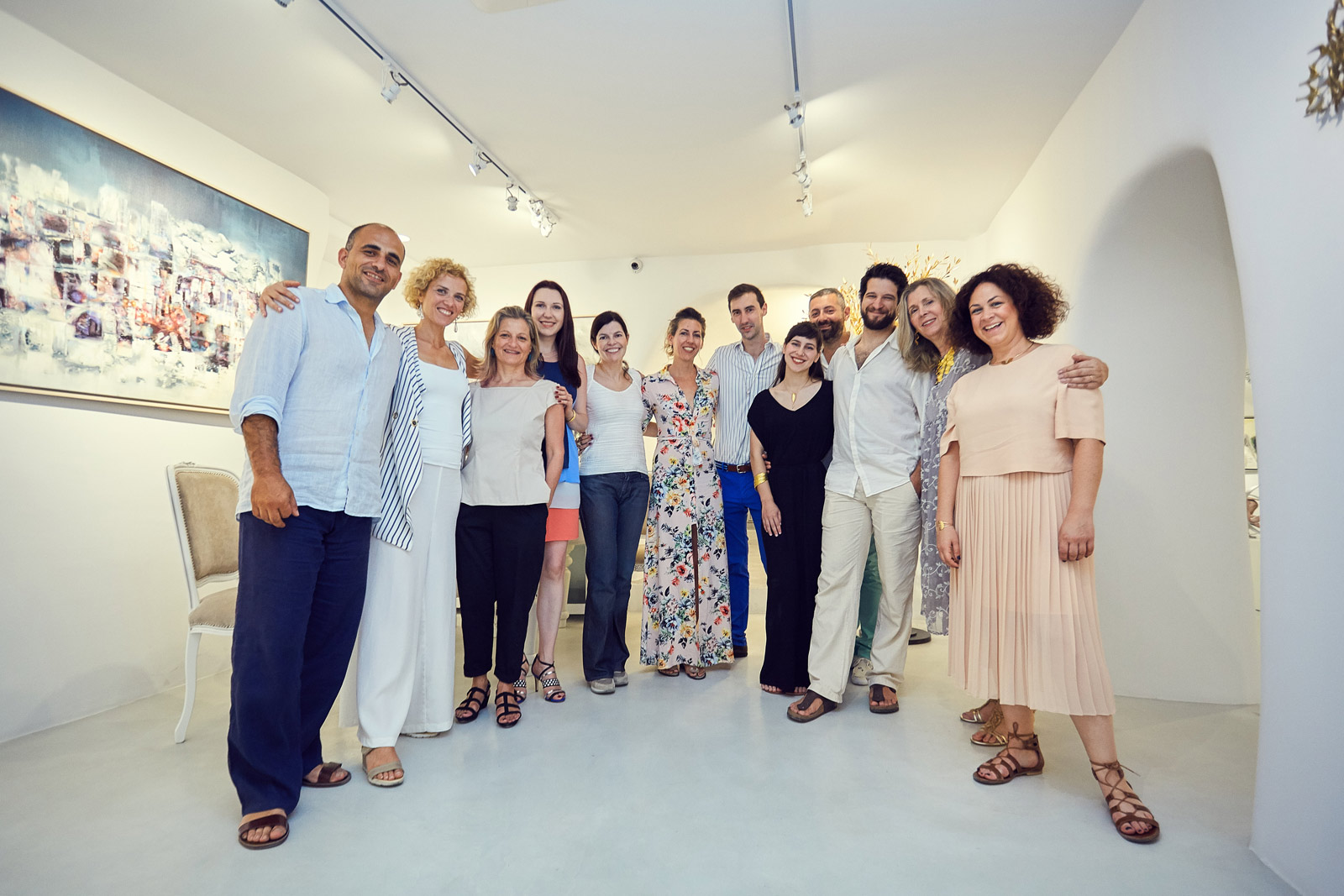 From left to right: Oia Treasures Gallery owners Flora Koutsi and Takis Panagopoulos, Annie Archimandritou, Katerina Perez, Alexandra Itouna, Evangelos Tsoukalas, Semeli and Labros, Mary Samoli and Katerina Kouloubourou