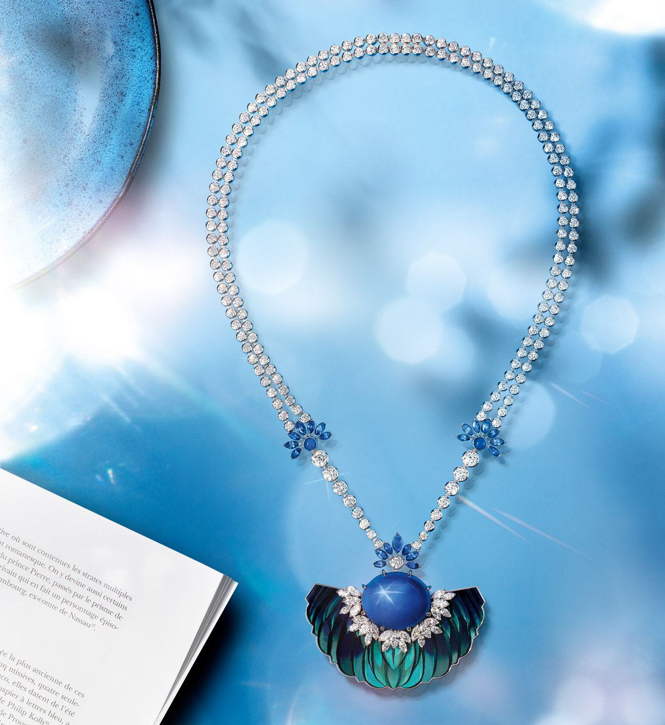  The Celestial Blue Necklace by Piaget in 18K white gold set with 1 oval-cut cabochon star blue sapphire from Ceylon (45.94 cts), blue sapphires and diamonds Feather marquetry