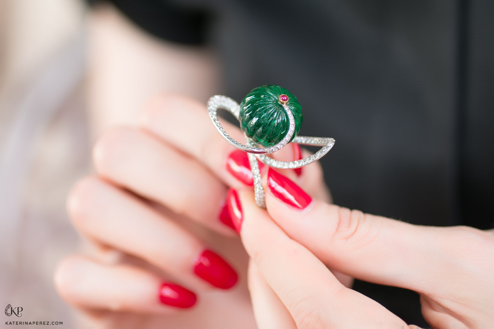  An old emerald melon carved bead set in a contemporary ring, which can spin in its setting