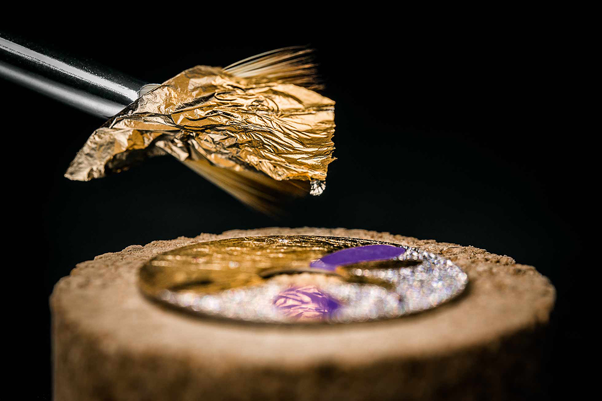  Gold leaf is applied during the process of creating a watch from the 'Dior Grand Bal Jardins Imaginaires' collection