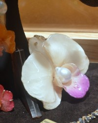 Fancs V. by Simona V. Elia. Resin coated orchid flower with a baroque pearl