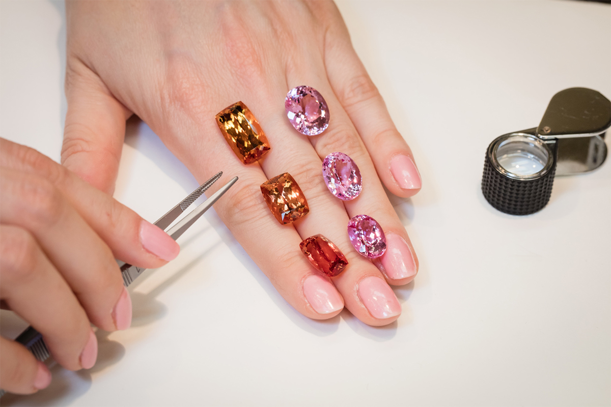Pastel pink, pink and hot pink topazes with their unheated counterparts in golden, golden-pink and reddish-orange Imperial topaz at Constantin Wild