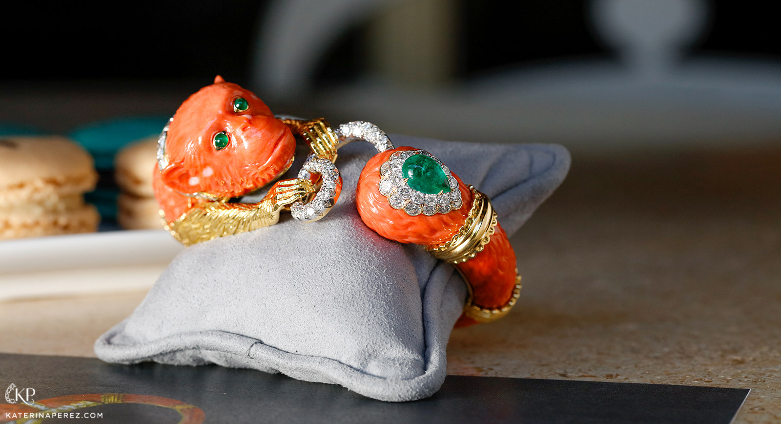 David Webb 'Monkey' bracelet with carved coral, cabochon emeralds and brilliant cut diamonds in 18k gold and platinum