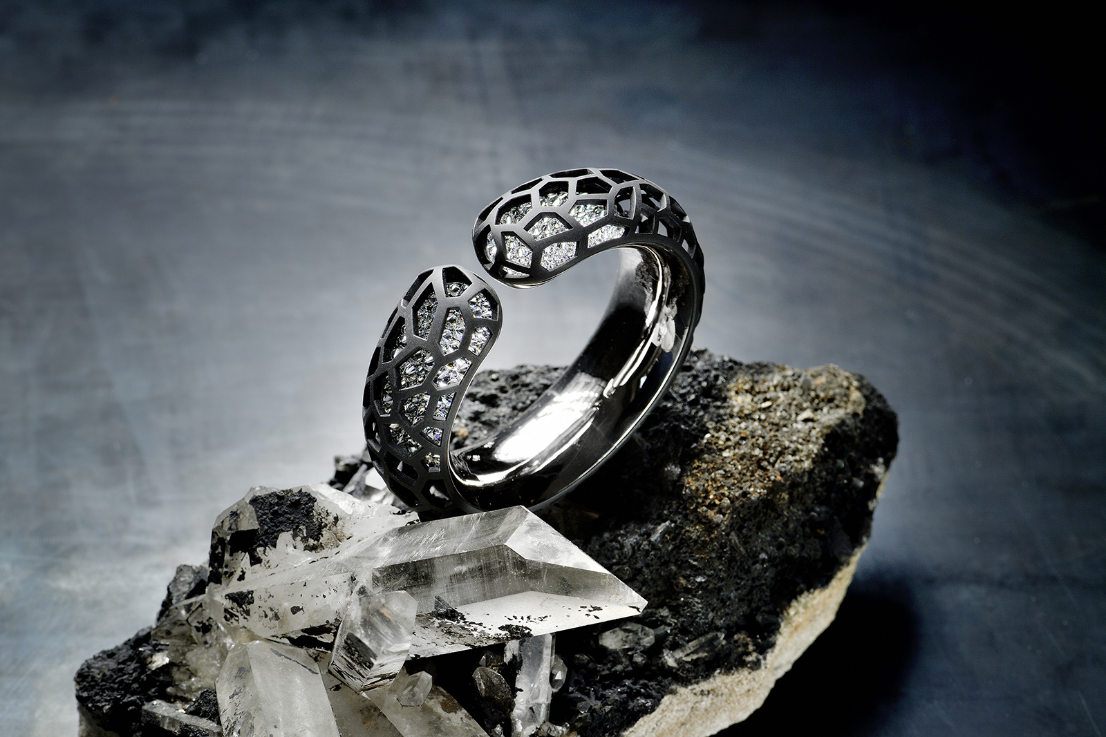 Hemmerle 'Harmony' bangle with reverse set diamonds, iron, silver and white gold. Image courtesy of Hemmerle