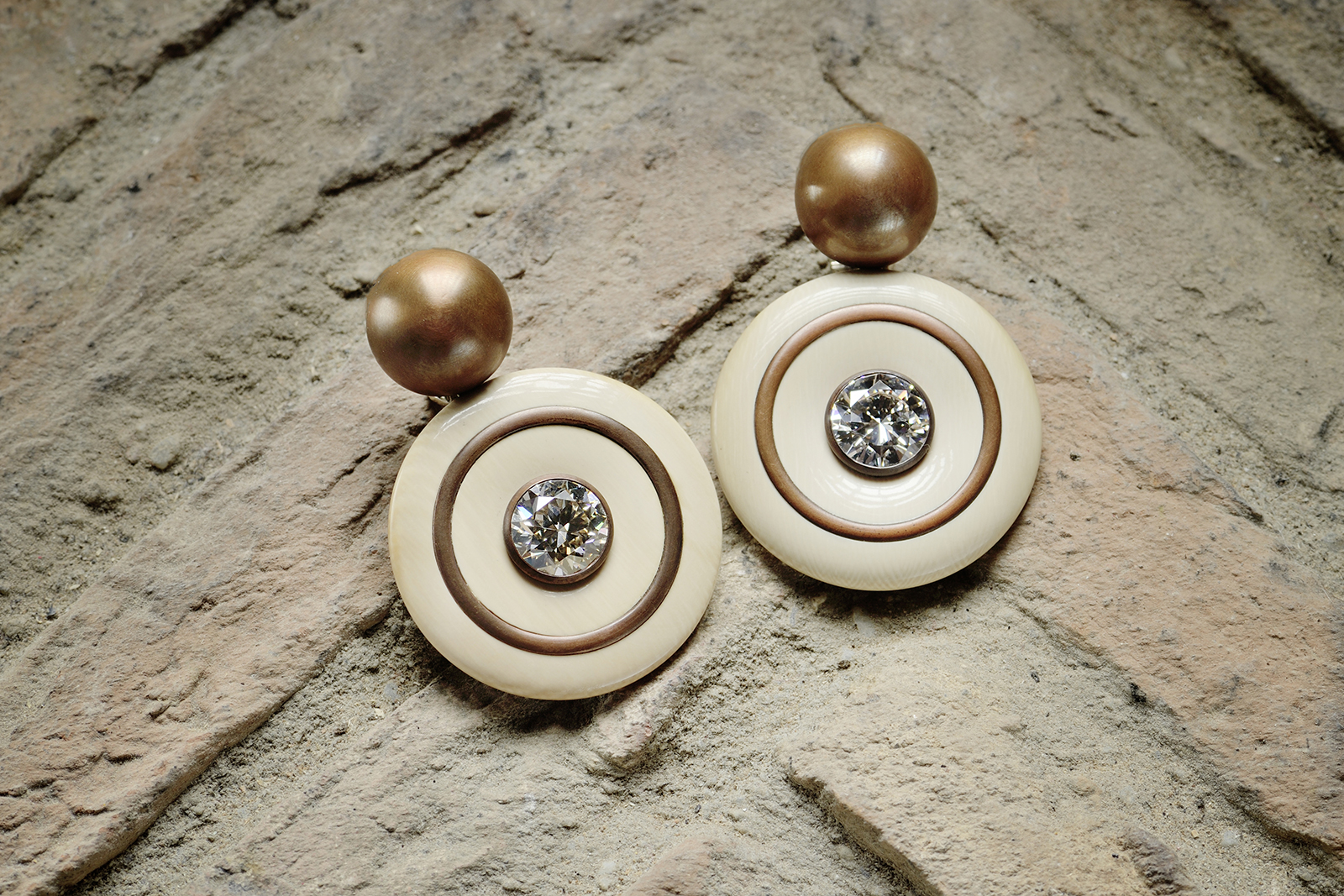 Hemmerle earrings with diamonds, mammoth, copper and white gold. Images courtesy of Hemmerle