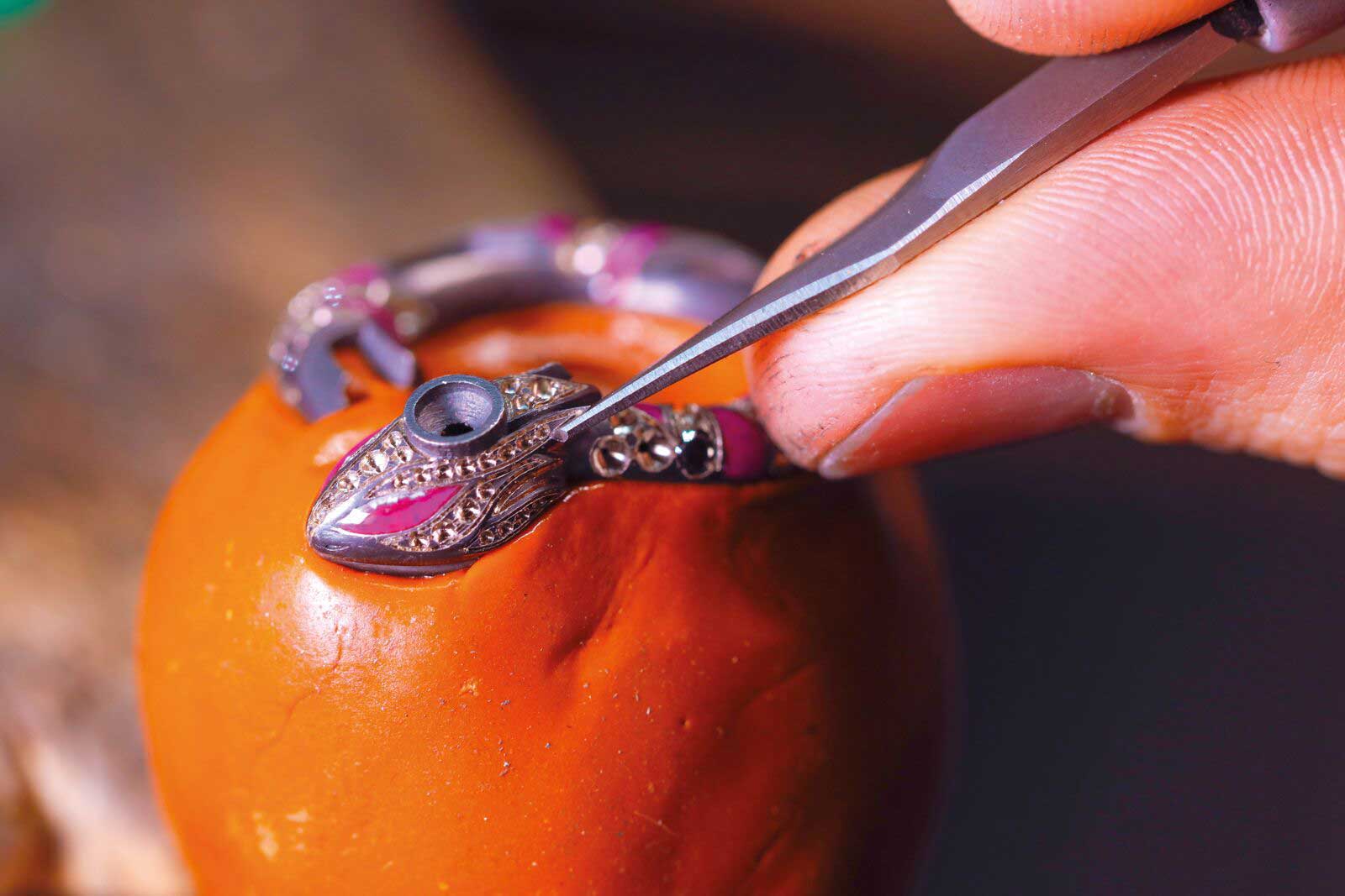  Making of the Jewellery Orchestra ‘Boa Constrictor' dis-engagement ring with 4 ct Colombian emerald, aquamarine, tsavorites, rubies, colourless and black diamonds and enamel in platinum, 18k yellow, pink and white gold