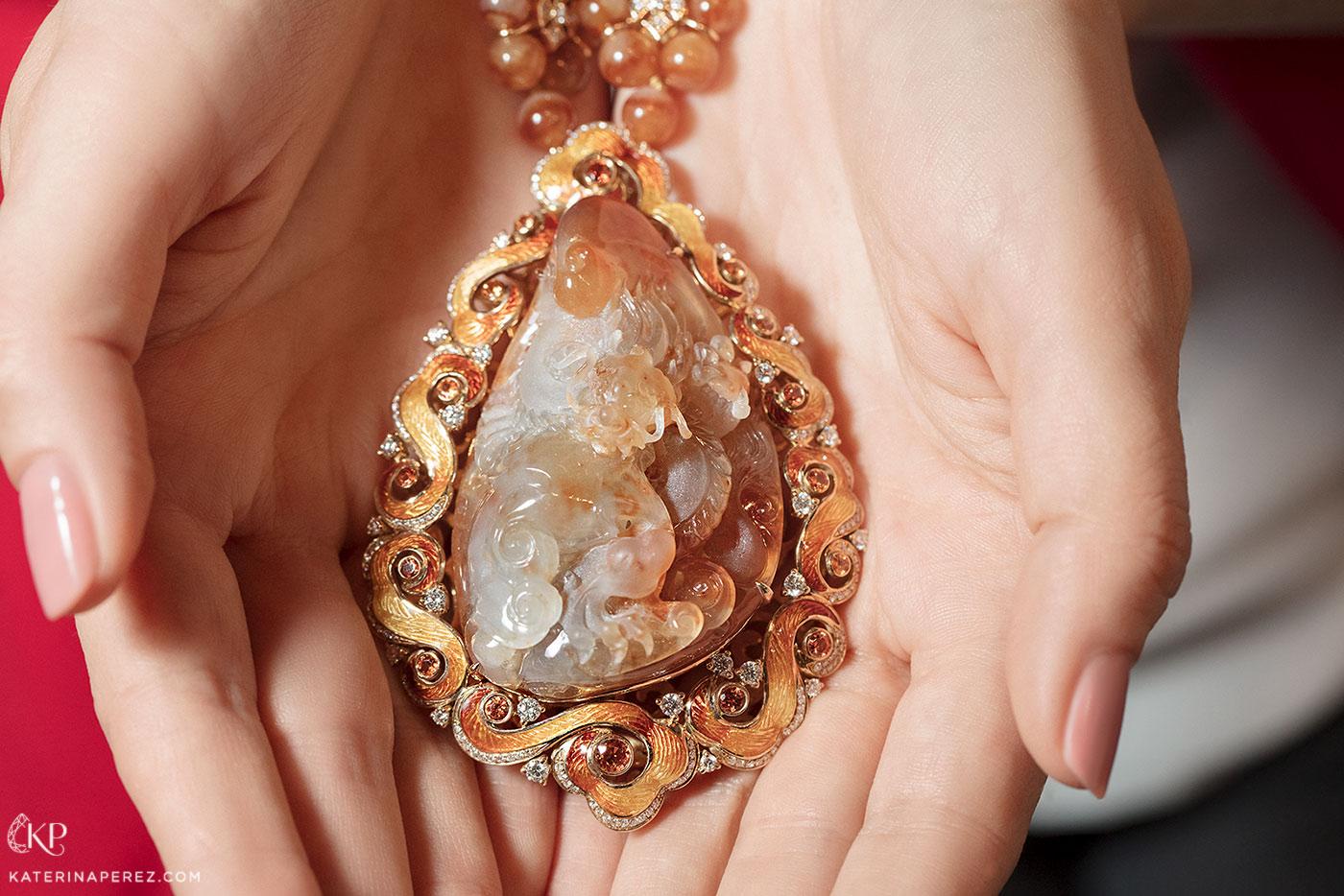  DAWN jewellery necklace with carved orange jade, orange jade beads, sapphires and diamonds in guilloché enamel and 18k red gold