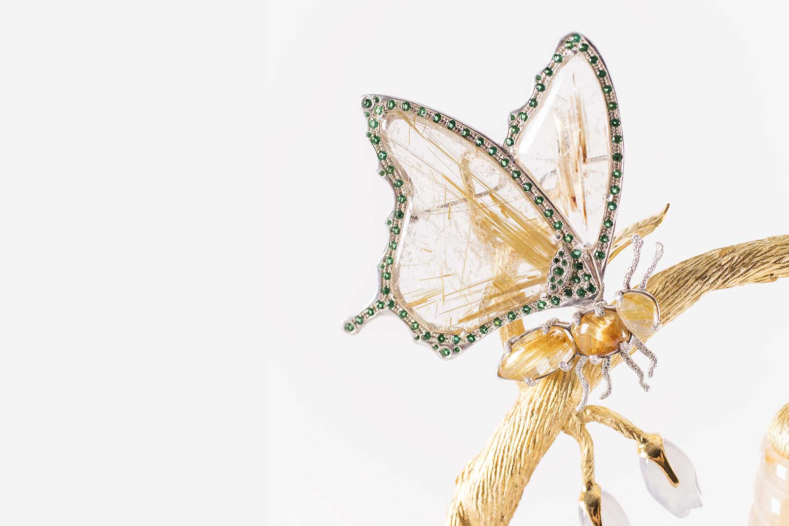 L’Aquart ‘Evolving Beauty’ ‘Butterfly Brooch’ in gold plated bronze, 69 faceted emeralds and Namibian chalcedony cabochons