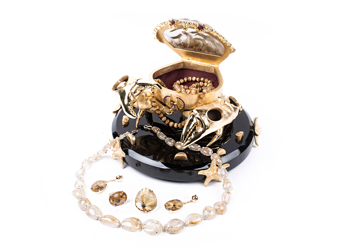 L’Aquart ‘The Crab Prince’ cross ring, pendant, necklace, and earrings in hand carved Brazilian golden rutilated quartz, gold and diamonds, and ‘Principe’ crab body clutch bag with obsidian