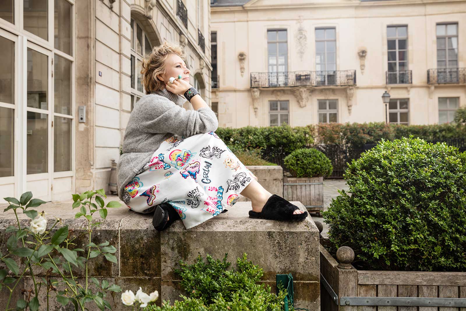 Second Pétale founder Arina Pouzoullic in a selection of vintage jewellery, including  cuff with enamel, emerald, ruby and champagne diamonds in silver