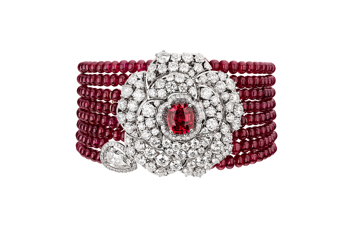 Chanel 'Rouge Incandescent' transformable bracelet, in white gold, rubies and diamonds. Detachable camellia motif that may be worn as a brooch, and reveals another openwork camellia motif