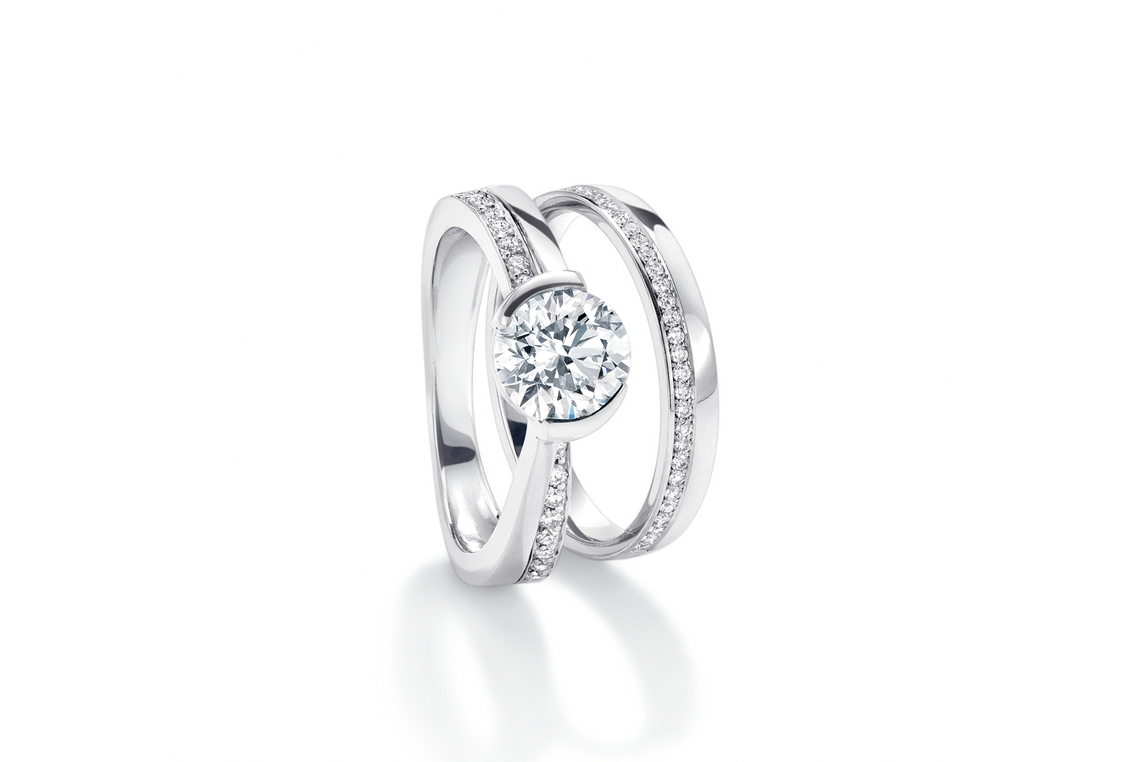  Boodles ‘Kiss’ engagement and wedding ring set, with brilliant cut feature diamond and accenting channel set diamonds in white gold
