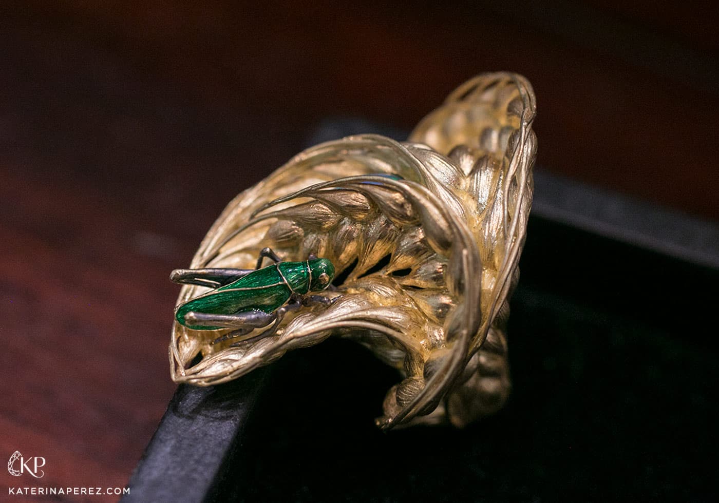  'Wind in a field' ring by Ilgiz.F made in sculptured yellow gold with enamelled grasshopper and an oval opal