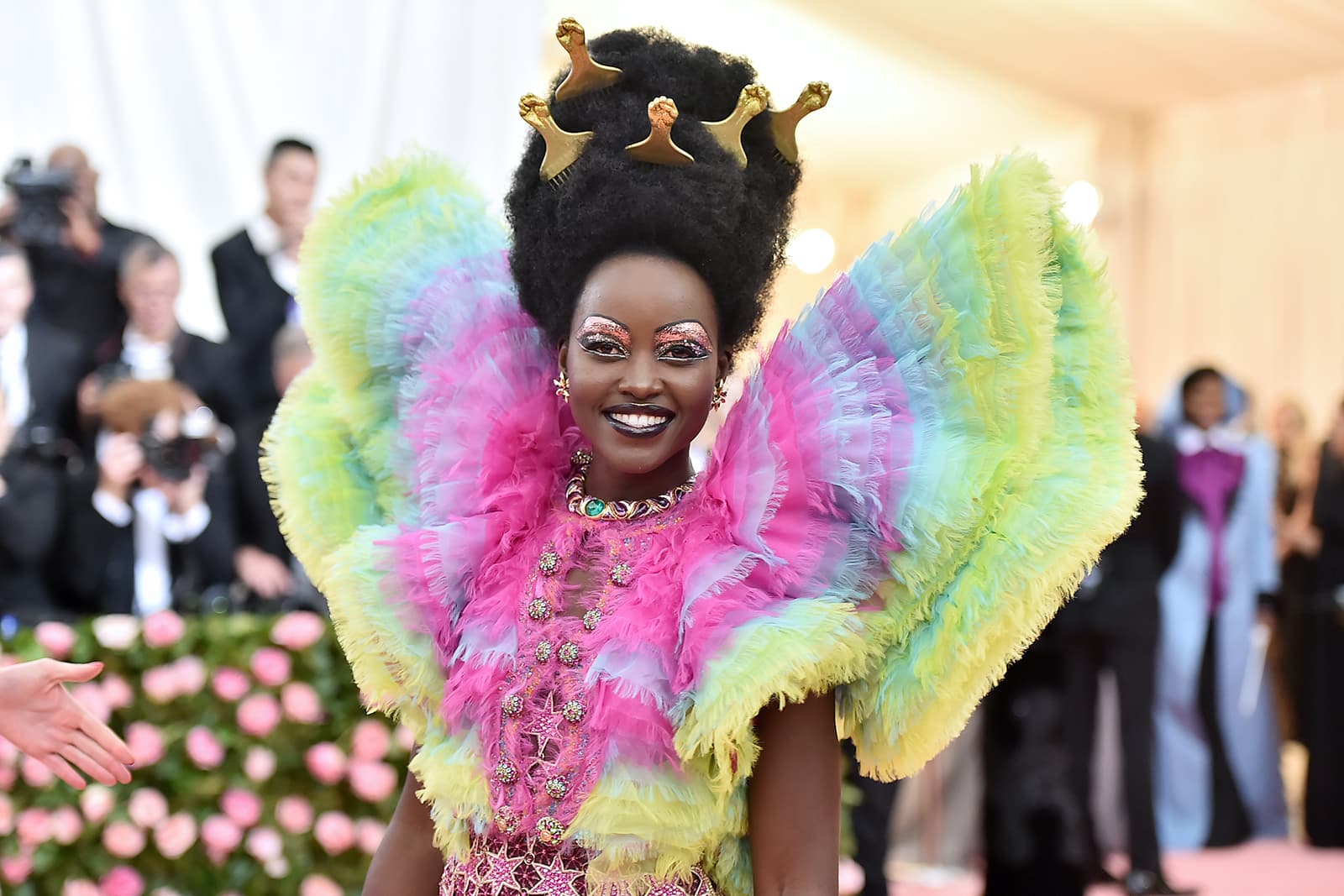 Lupita Nyong'o wearing suite of Bulgari archival and 'High Jewellery' collection jewellery with emerald, amethyst, ruby, sapphire, diamond, tourmaline and pearl in 18k yellow gold, white gold and platinum