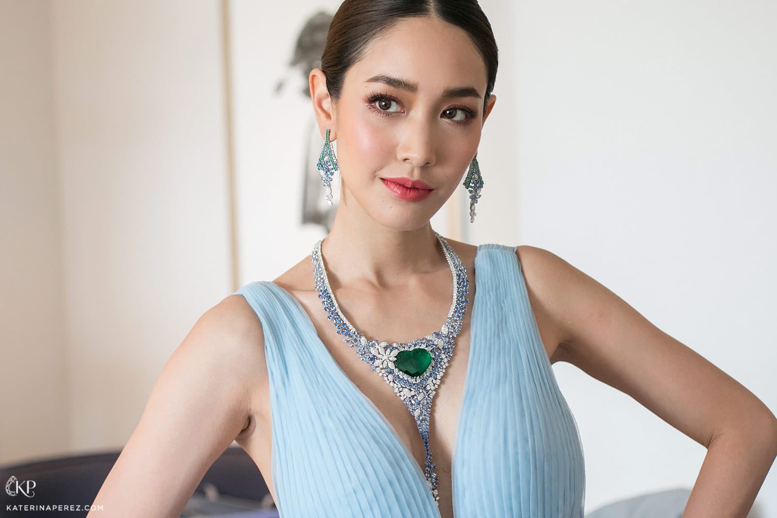 Pechaya Wattanamontree wearing AVAKIAN earrings and necklace with 40ct heart shaped Colombian emerald, diamonds and sapphires