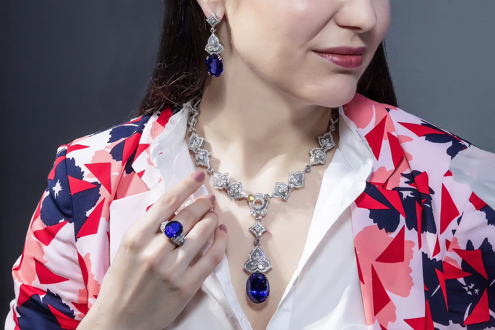 Henn of London necklace with 61.11ct oval tanzanite, earrings with 48.83ct oval tanzanite, and ring with 18.27ct oval tanzanite, all with diamonds and enamel in 18k white gold