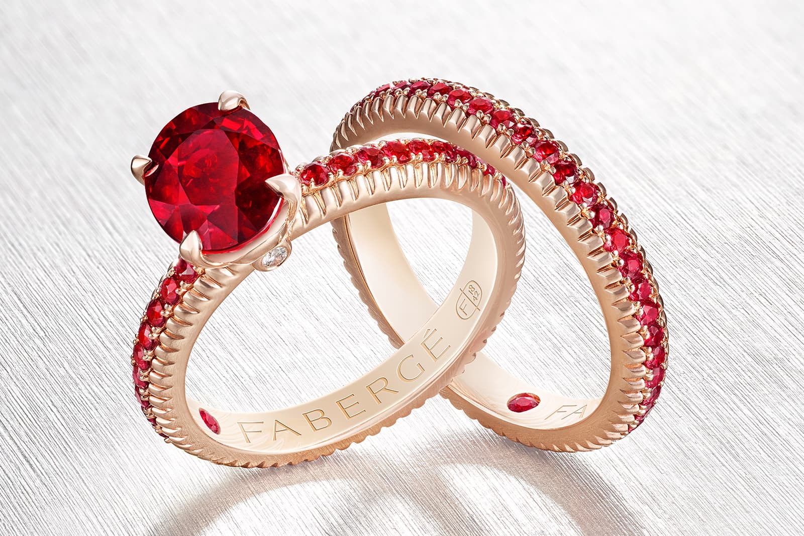 Fabergé 'Three Colours of Love' rings, both with rubies in rose gold