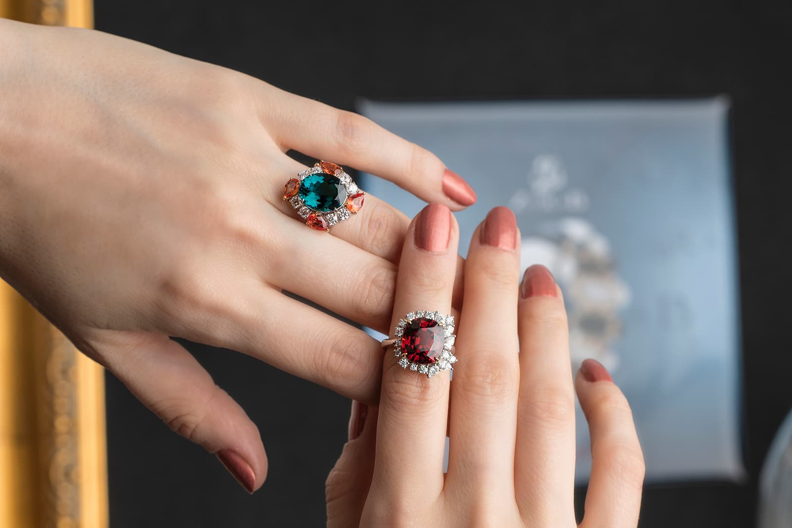 Left: blue tourmaline ring with padparadscha sapphires and diamonds, right: spessartite garnet ring with diamonds by Jessie Foo