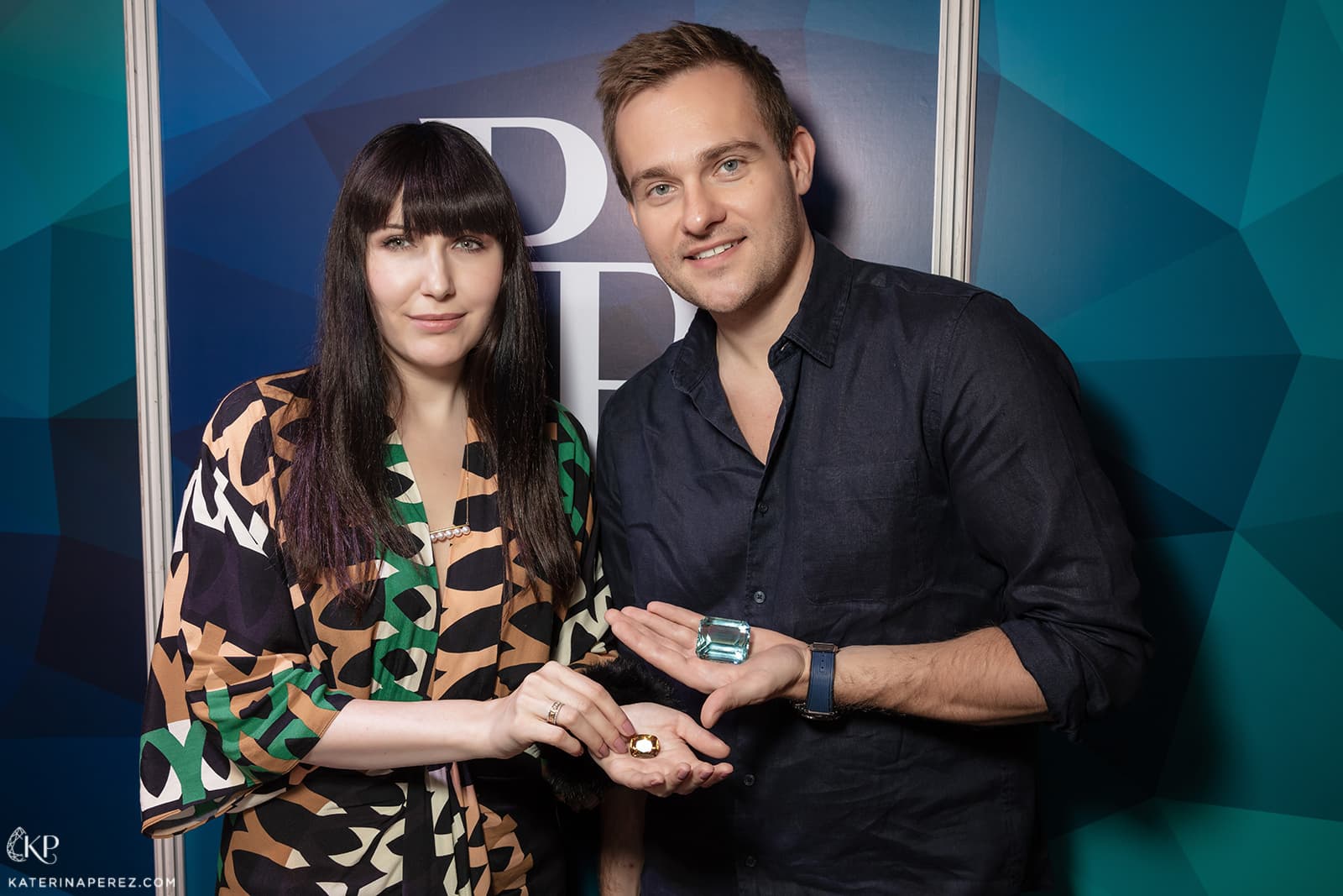 Katerina Perez holding a sphene and Ilya Podnebesny holding a 450 cts aquamarine from Brazil. Photo by Simon Martner