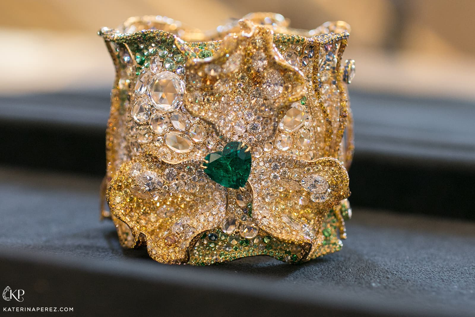 Cindy Chao 2019 Black Label Masterpiece XVIII Emerald Sculptural Bangle from the Four Season Collection with 7.61ct heart shaped Colombian emerald, 71.88 ct of diamonds, 77.24ct fancy coloured diamonds, sapphires, demantoid garnets, colour change garnets, tsavorites and alexandrites in yellow gold