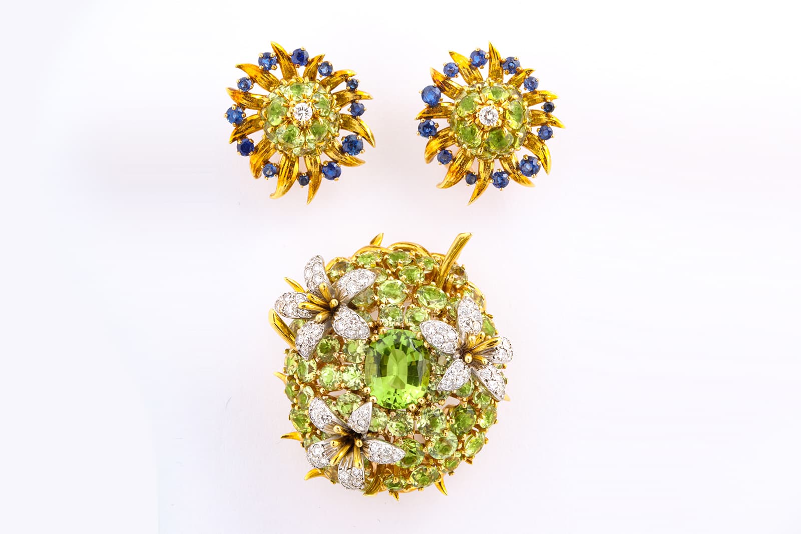  Offered by A la Vieille Russie, Jean Schlumberger for Tiffany&Co. earrings with sapphires, and both with peridot and diamonds in yellow gold