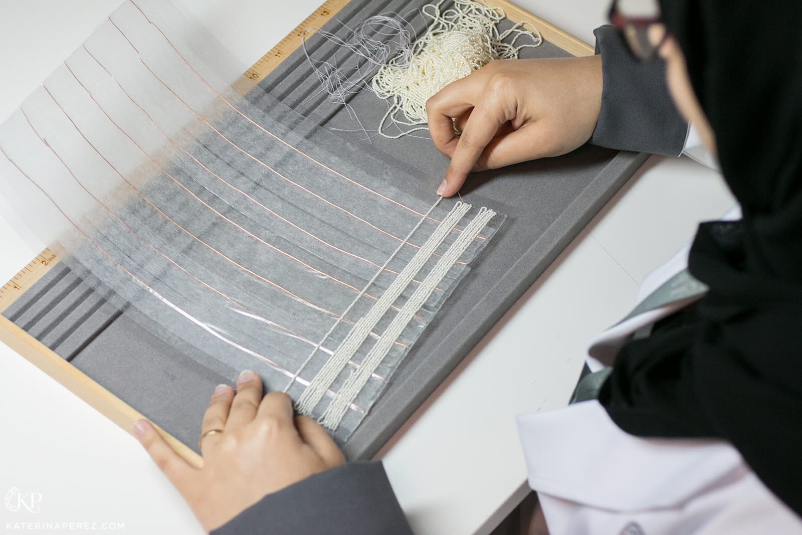  Pearls are laid out on a sticky sheet for further testing in machines