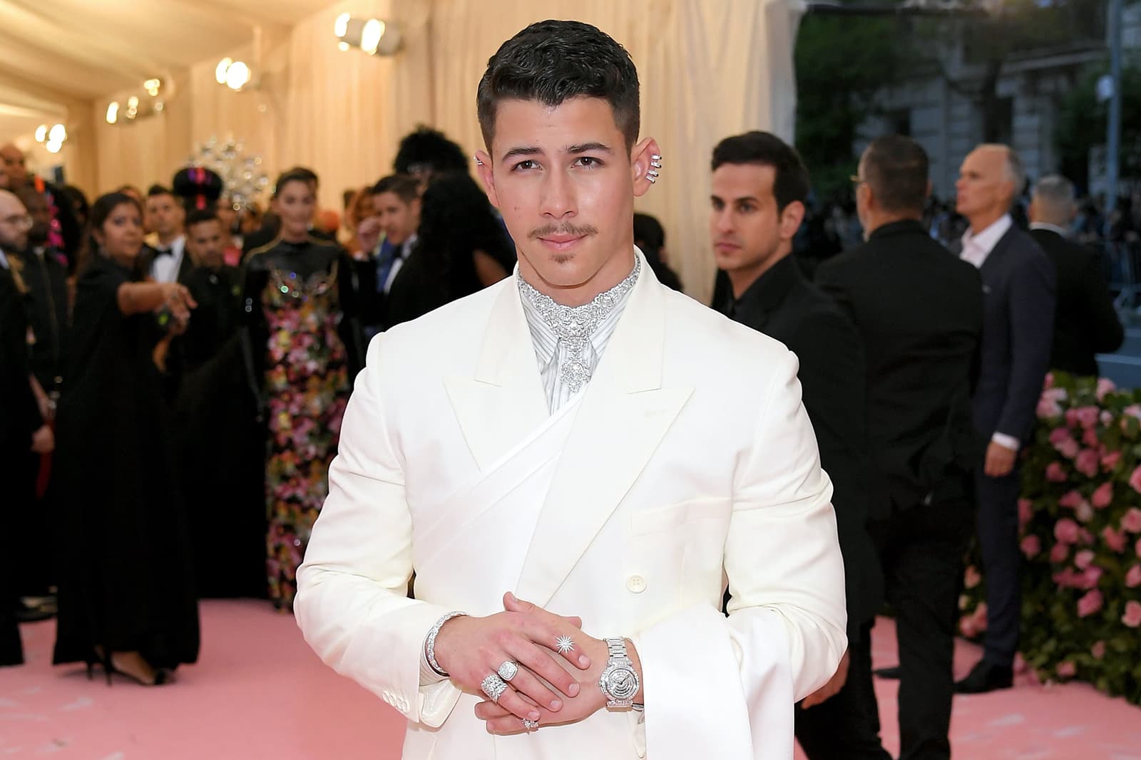 Nick Jonas wearing Chopard jewellery, including a necklace from the ‘Precious Lace Collection,’ a ring from the ‘Green Carpet Collection’, and watch from the ‘Imperiale Collection’ - all in diamonds in 18k white Fairmined gold