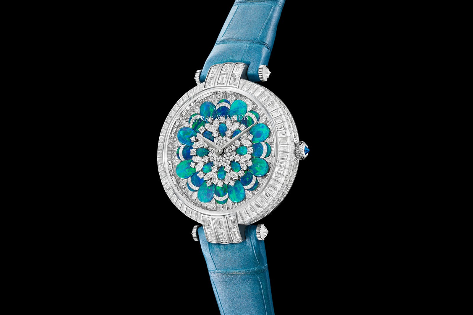 A row of invisibly set baguette cut emeralds encircles the opal and diamond dial