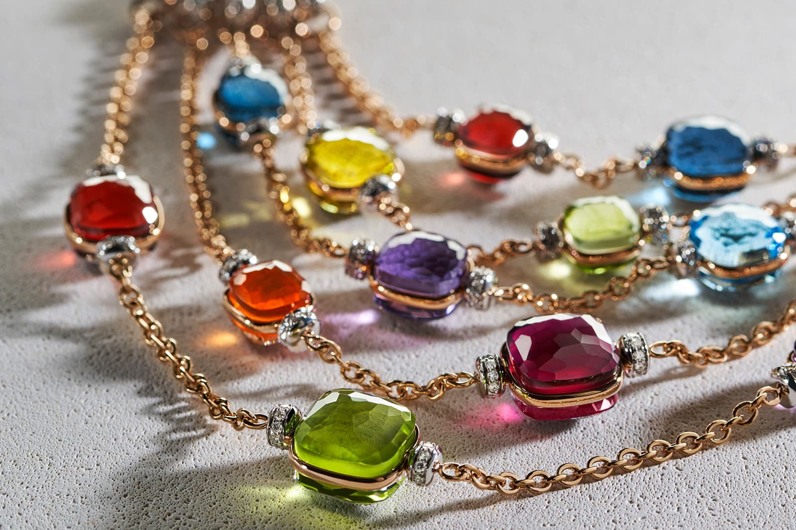  Blue topaz, moss-green peridot, lilac amethyst, sparkles of orange spessartine, raspberry shades of tourmaline, lemon-yellow quartz and waves of pink rhodolite create a rainbow effect